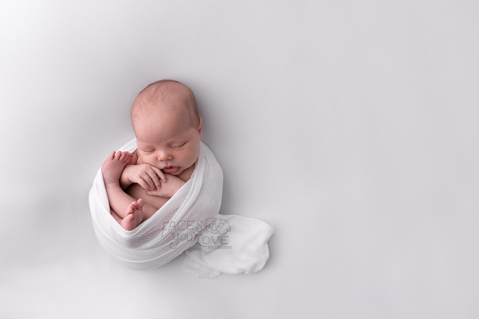 simple newborn portrait, newborn on white, curly newborn pose, kansas city newborn photographer