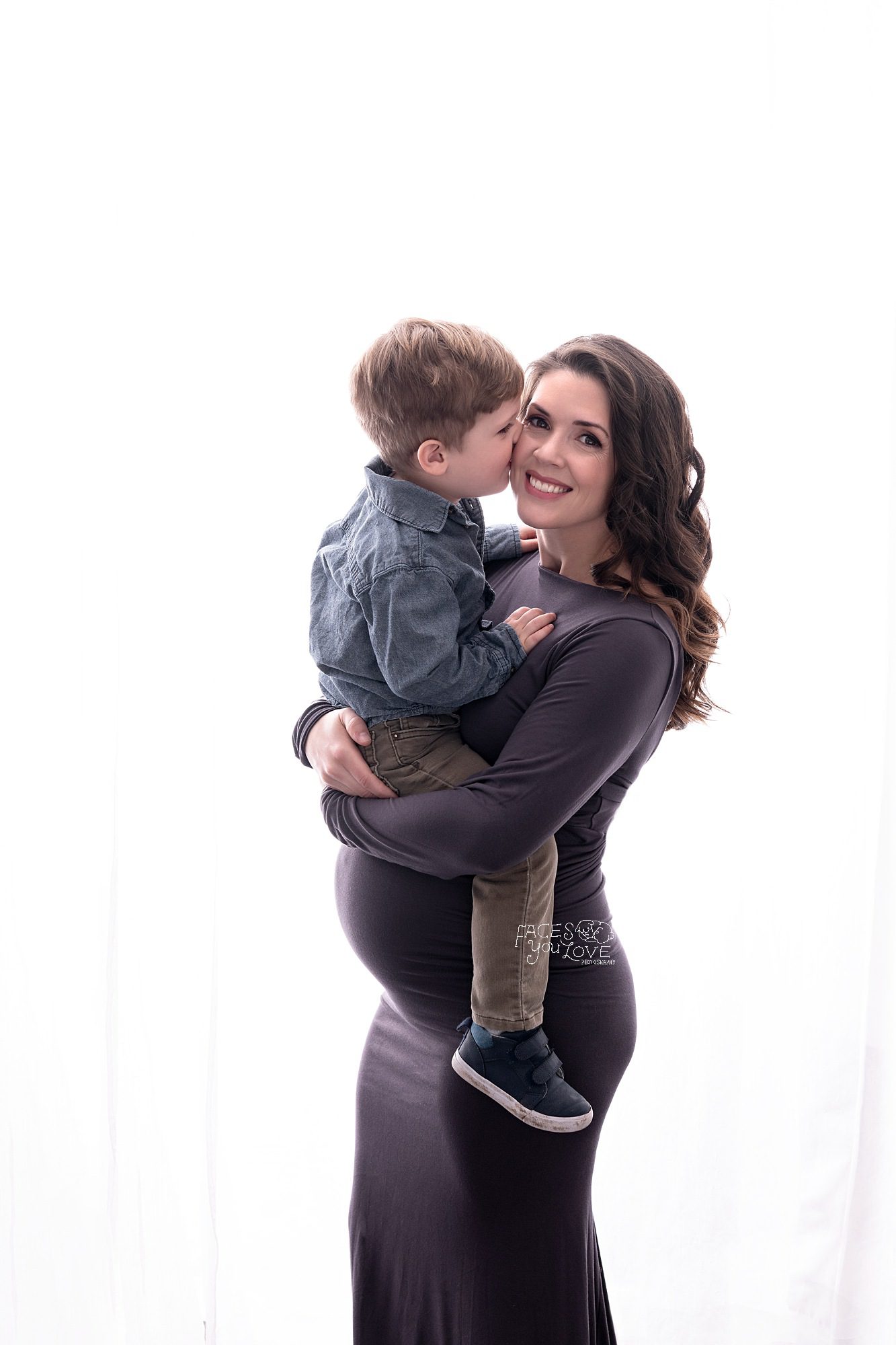pregnant mother holding son, gray maternity dress, studio maternity portraits, Kansas City photographer
