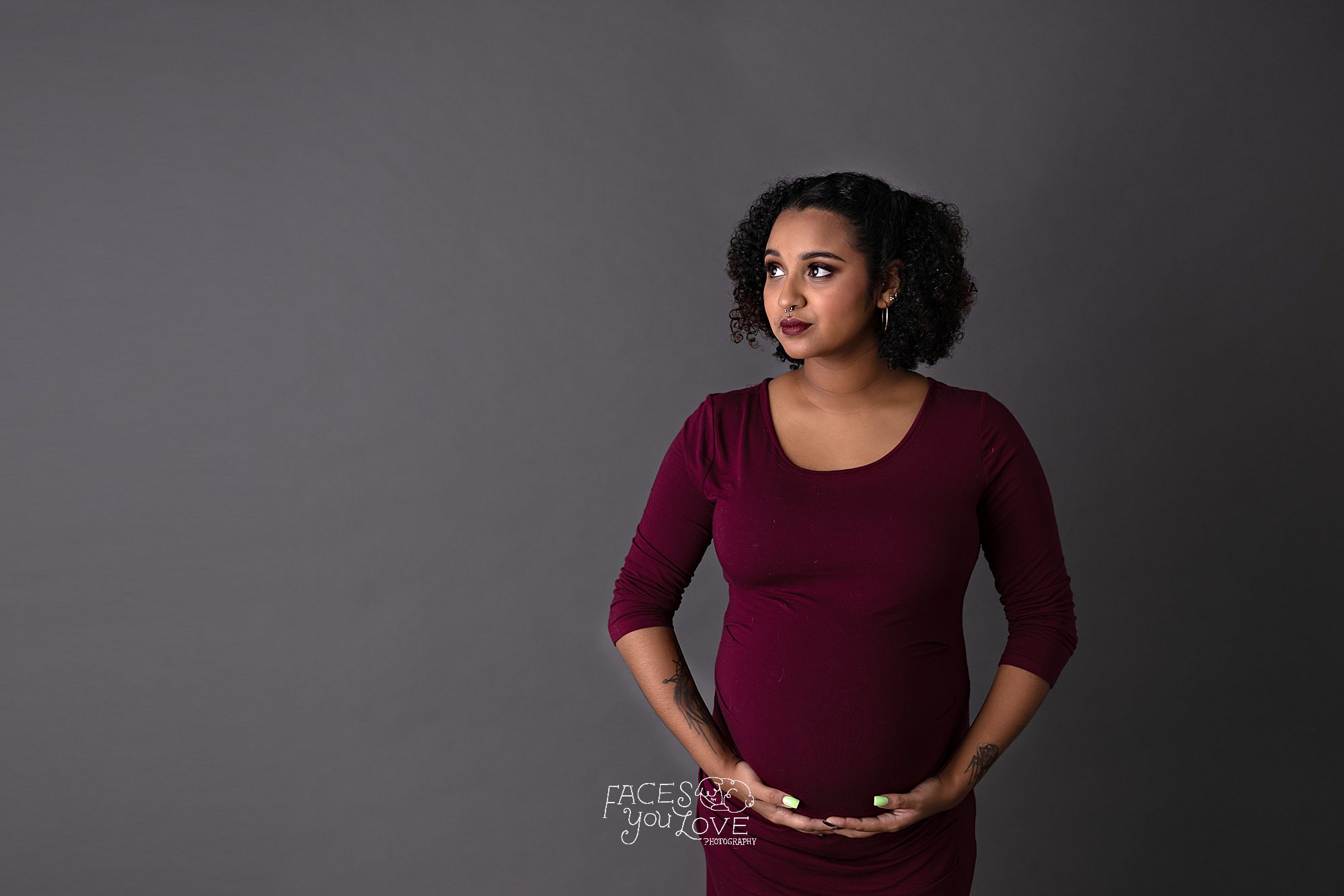 maroon dress on gray background, serious maternity portrait, expecting, pregnancy portraits, Kansas City professional photographer