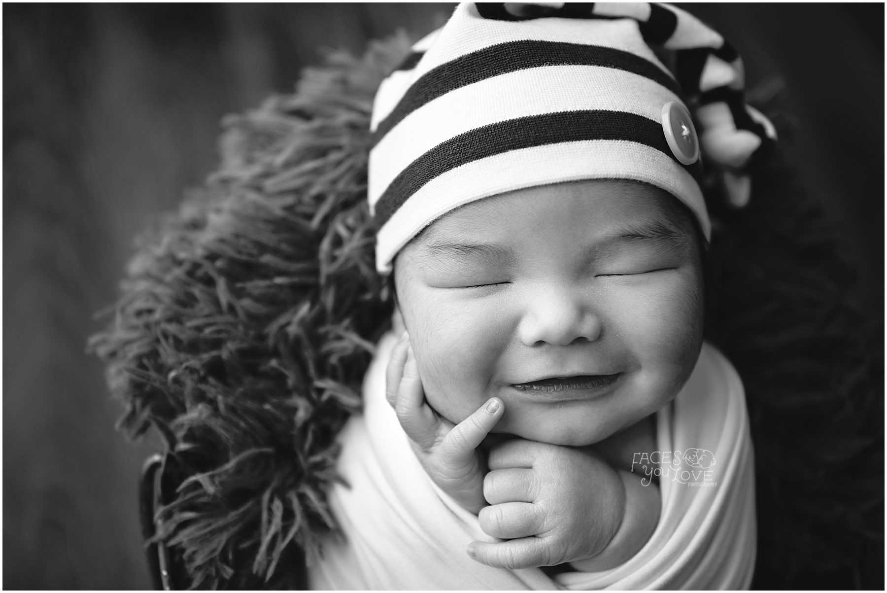 smiling newborn, black and white newborn, newborn in striped hat, wrapped newborn session, swaddled newborn, Kansas city newborn photography 