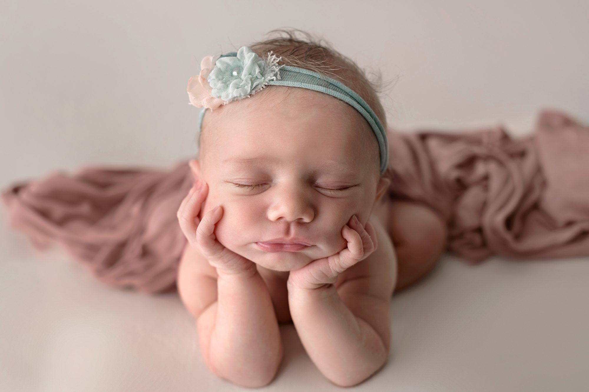 Newborn girl in froggy pose at her newborn session with Faces You Love in Overland Park.